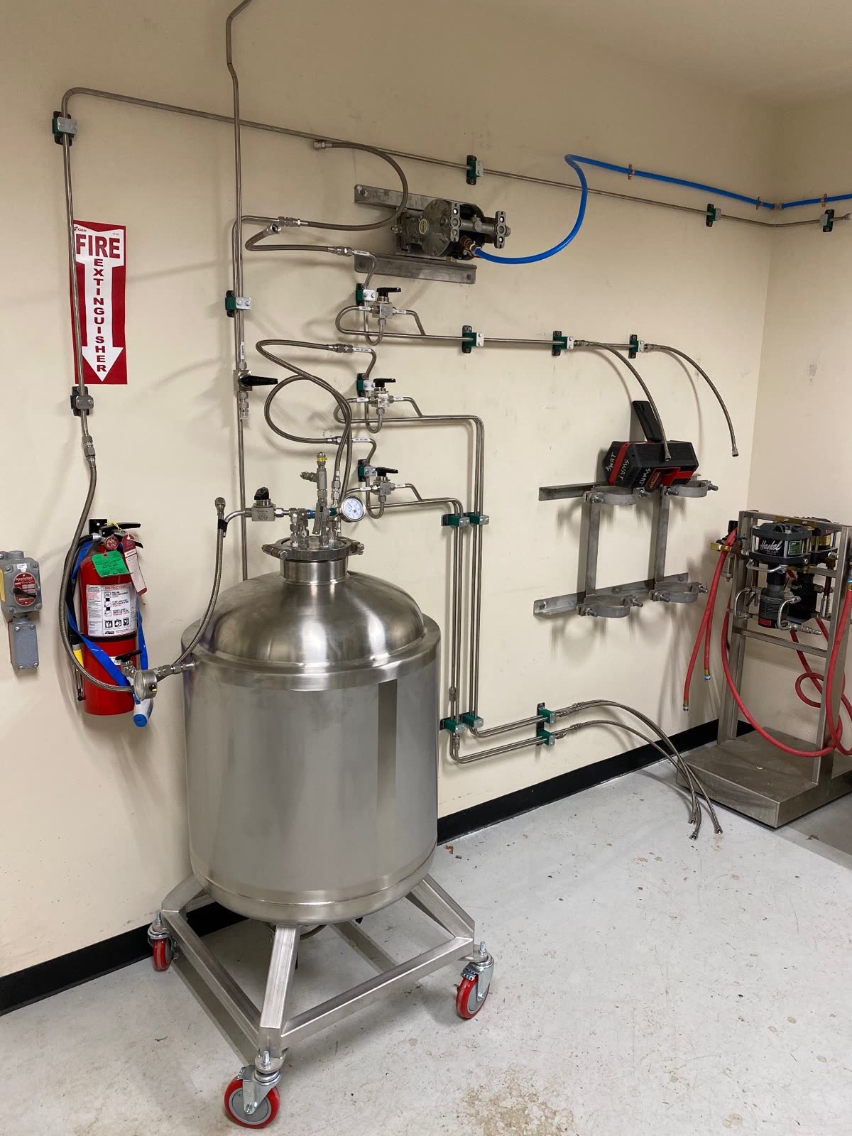 Stainless vessel and process piping installed on a wall