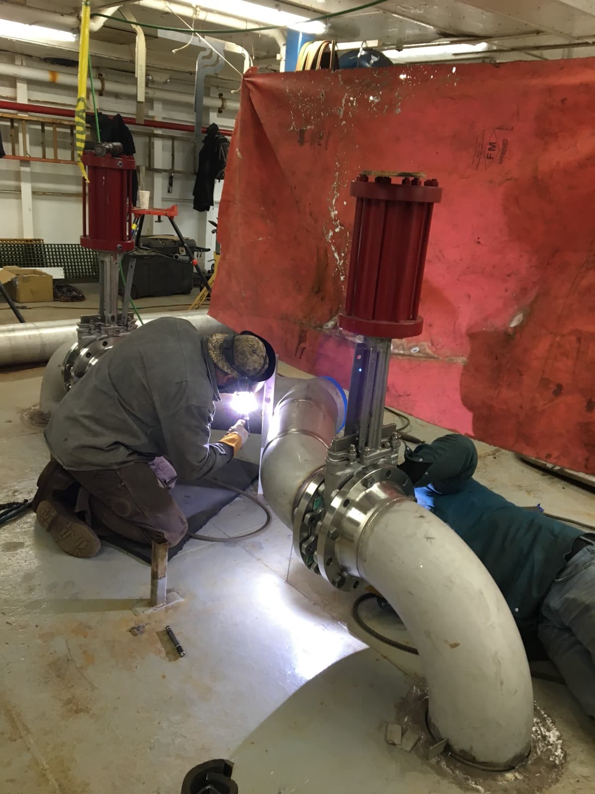 Welding a large-diameter pipe fitting on the shop floor